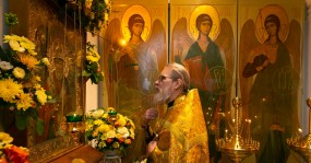 священник молится святому