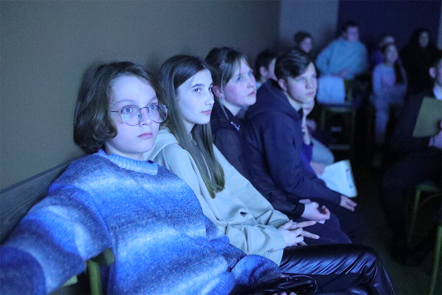 подростки внимательно смотрят кино